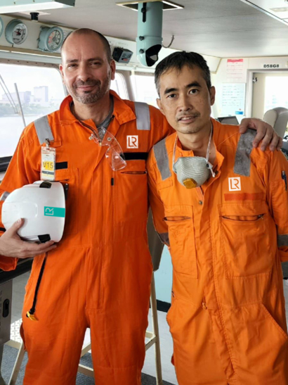 Two maritime workers on a ship. 
