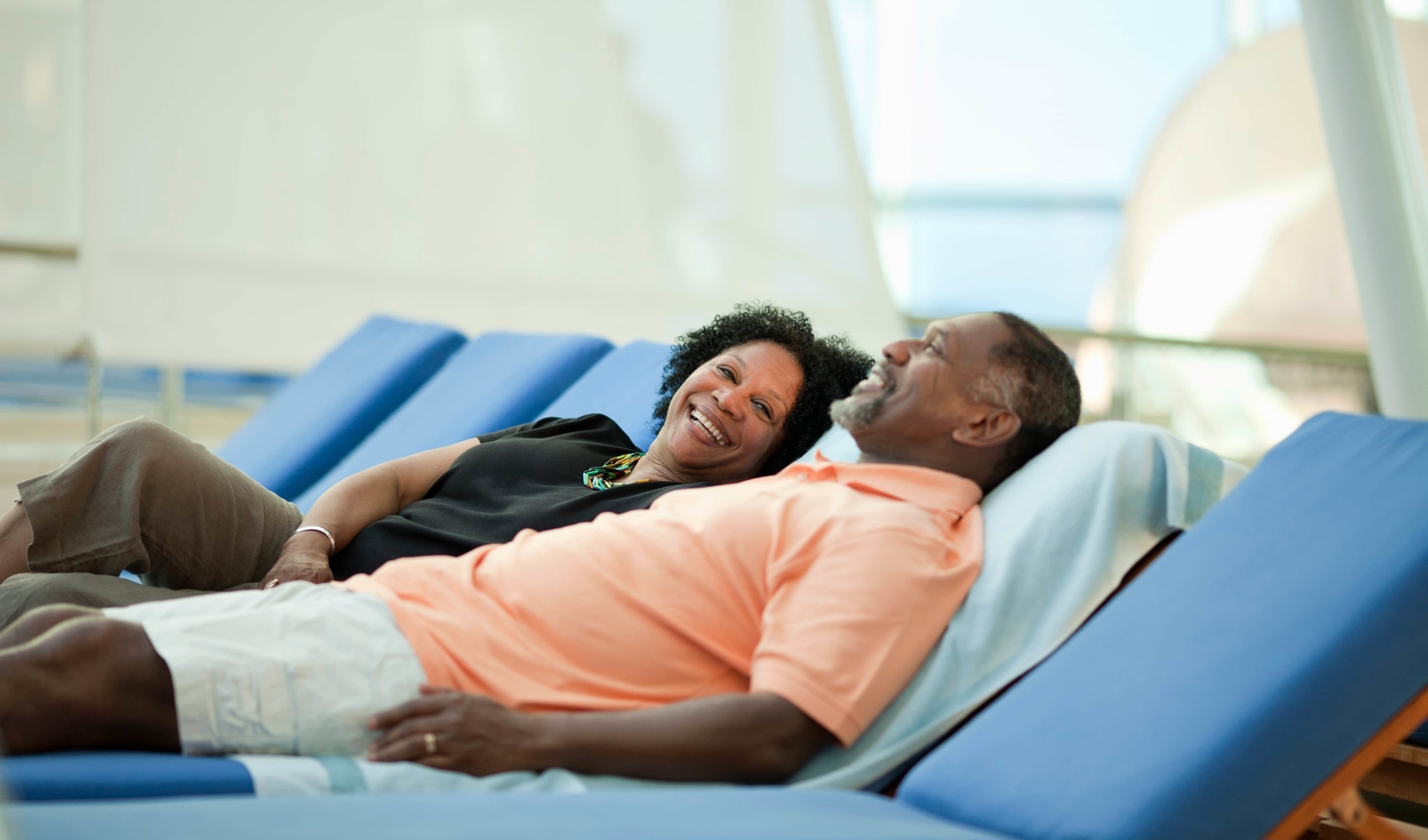 Two cruise passengers recline happily.